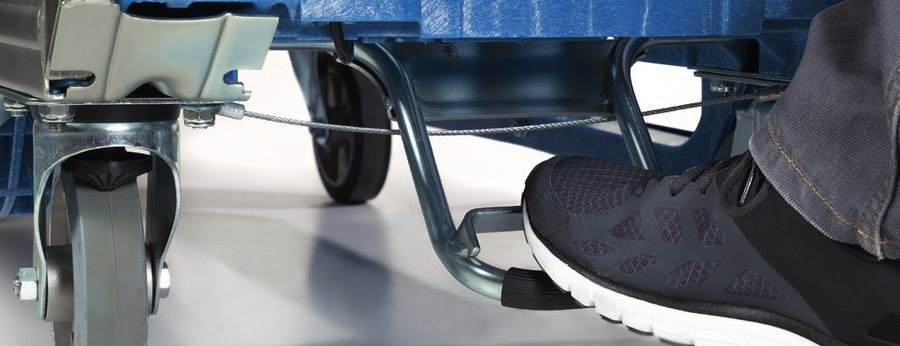 Foot pressing the parking brake on a Loggyflex castor
