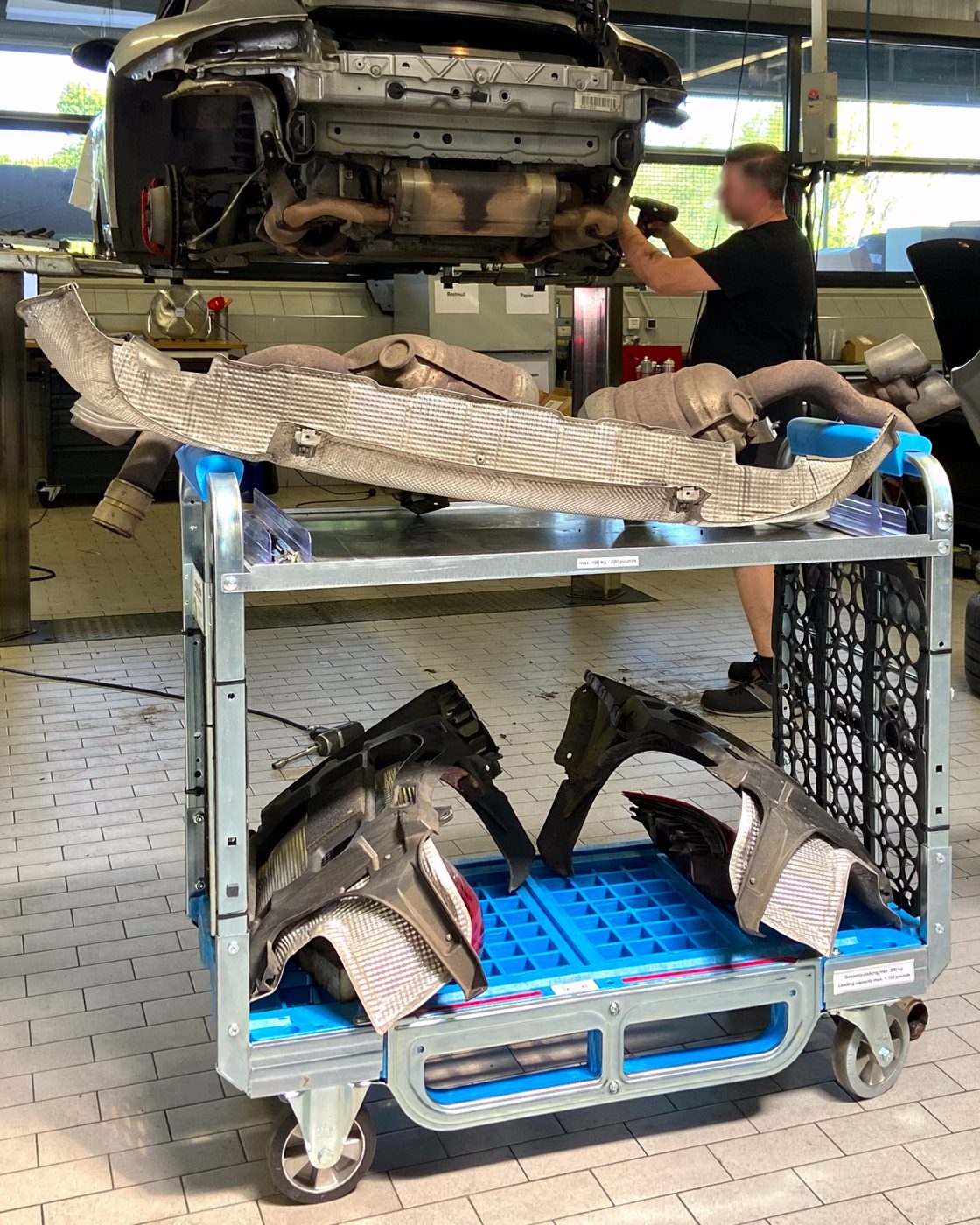 Loggyflex Duo mini with heat shield and wheel arch liners under a vehicle on the lift