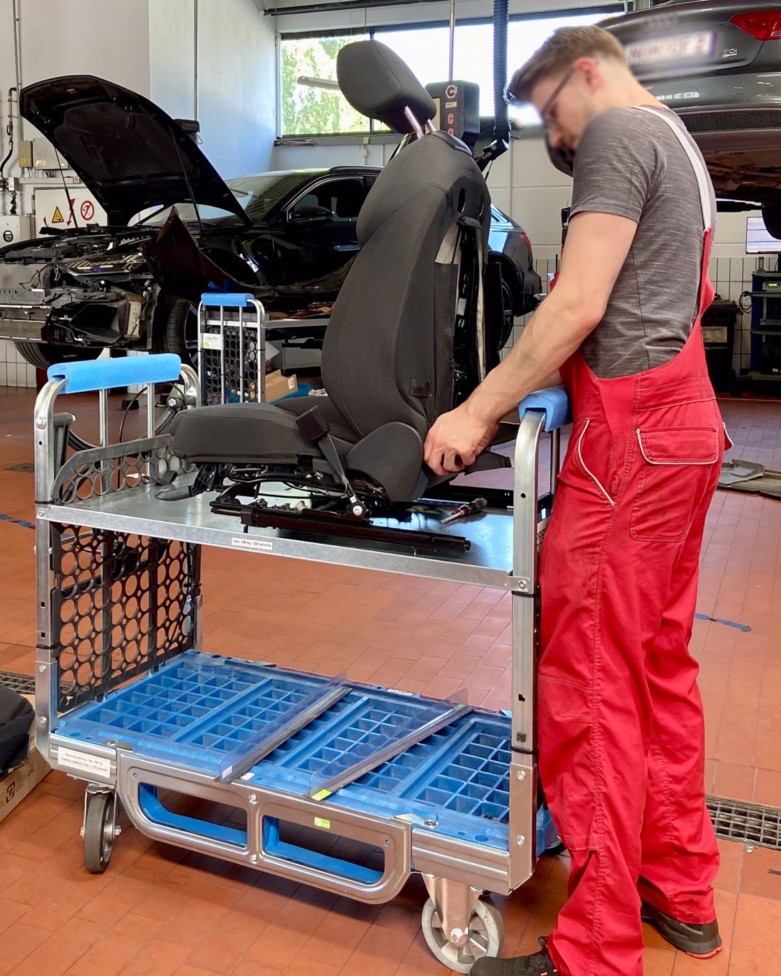 Mechanic working on a removed vehicle seat on the Loggyflex Duo mini